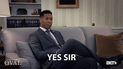 Man In Suit Sitting On Couch Saying Yes Sir GIF