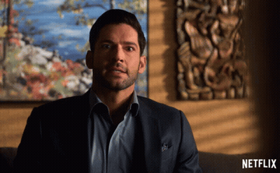Man In Suit Sitting On Couch With Netflix Logo GIF