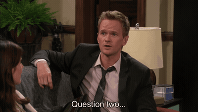 Man In Suit Sitting On Couch With Woman Saying Question Two GIF