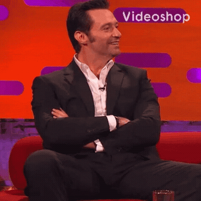Man In Suit Sitting On Red Couch With Videoshop Logo GIF