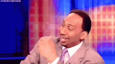 Man In Suit Sitting On Stage GIF