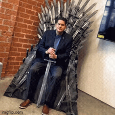 Man In Suit Sitting On Throne With Sword GIF