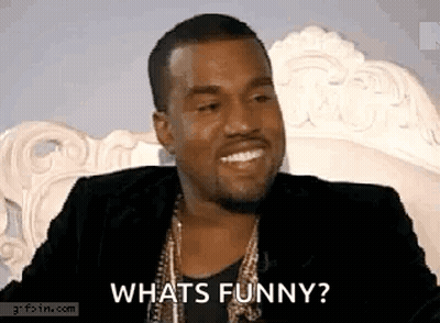 Man In Suit Sitting On White Chair Asking What's Funny GIF