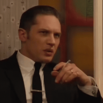 Man In Suit Sitting Saying Very Good GIF