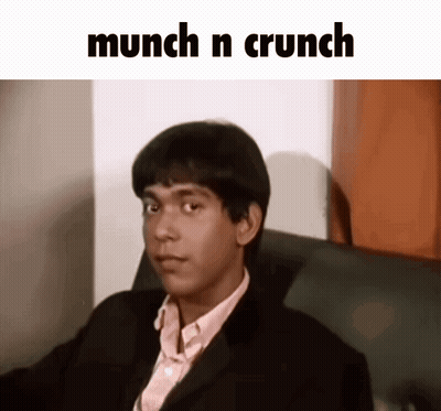 Man In Suit Sitting Under Munch N Crunch GIF