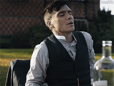 Man In Suit Sitting With Alcohol Bottle GIF