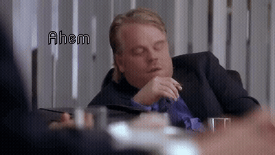 Man in Suit Sitting With Eyes Closed Saying Ahem
