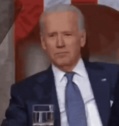 Man In Suit Sitting With Glass Of Water GIF