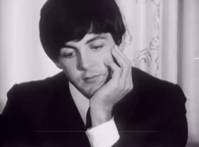 Man In Suit Sitting With Hand On Chin GIF