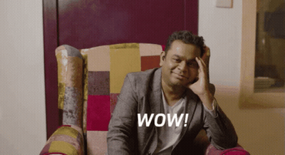 Man In Suit Sitting With Hand On Forehead Wow GIF