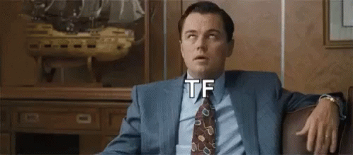 Man In Suit Sitting With Hand On Knee GIF