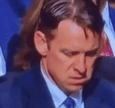 Man In Suit Sitting With Head In Hands GIF