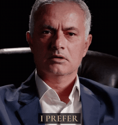 Man In Suit Sitting With I Prefer Sign GIF
