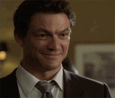 Man In Suit Smiling And Making Funny Face GIF