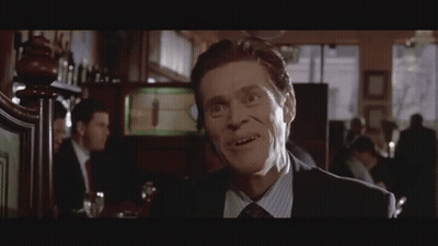 Man In Suit Smiling At Bar GIF