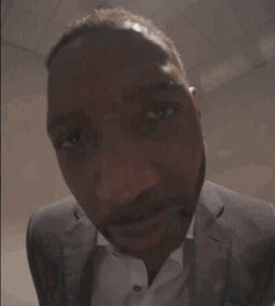 Man In Suit Smiling At Camera GIF