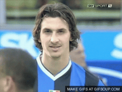 Man In Suit Smiling At Desk GIF