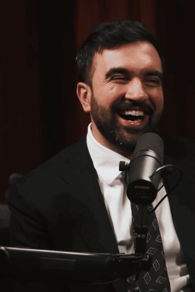 Man In Suit Smiling At Microphone GIF