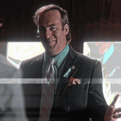 Man In Suit Smiling Holding Phone GIF