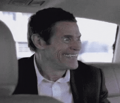 Man In Suit Smiling In Back Seat Of Car GIF