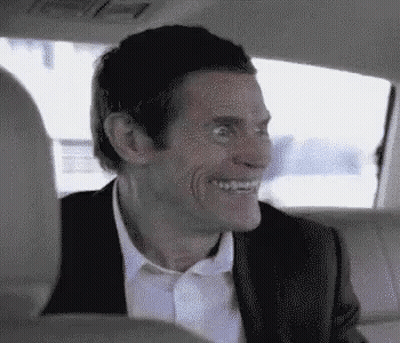 Man In Suit Smiling In Back Seat Of Car GIF