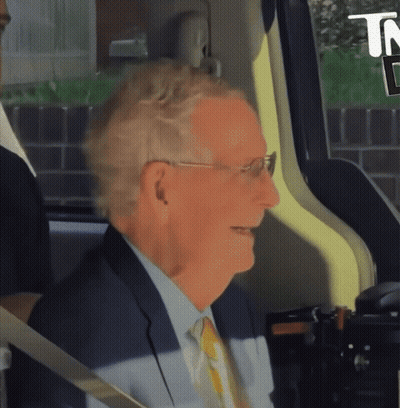 Man In Suit Smiling In Back Seat Of Car GIF