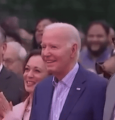 Man In Suit Smiling In Crowd GIF