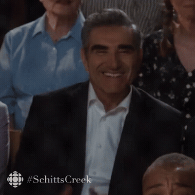 Man In Suit Smiling In Crowd GIF