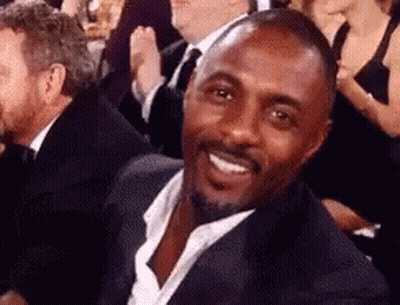Man In Suit Smiling In Crowd GIF