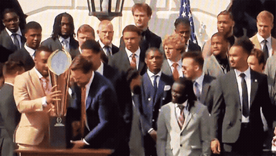 Man In Suit Smiling In Crowd GIF