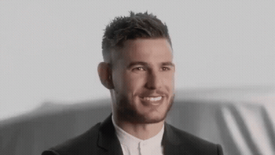 Man In Suit Smiling In Front Of Car GIF
