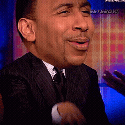 Man In Suit Smiling In Front Of Eeterbow Sign GIF