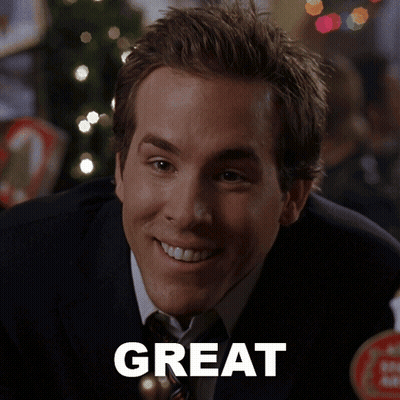 Man In Suit Smiling In Front Of Great Sign GIF