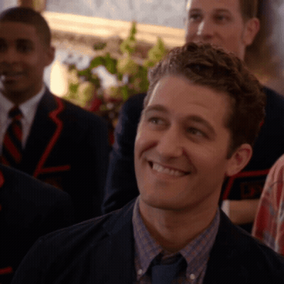 Man In Suit Smiling In Front Of Group GIF