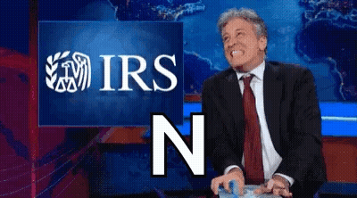 Man In Suit Smiling In Front Of IRS Screen GIF