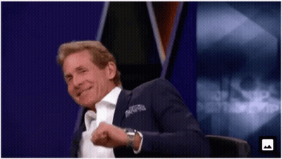 Man In Suit Smiling In Front Of Purple Background GIF