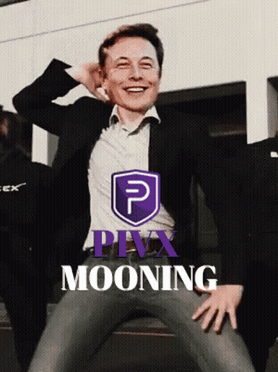 Man In Suit Smiling In Front Of Purple Pivx Mooning Logo GIF