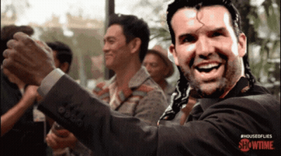 Man In Suit Smiling In Front Of Showtime Sign GIF