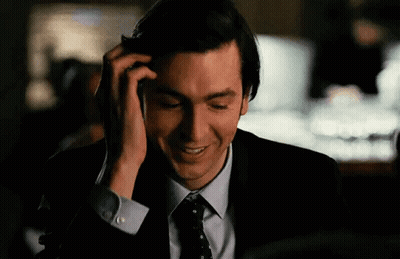 Man In Suit Smiling On Cell Phone GIF