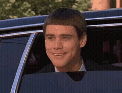 Man In Suit Smiling Out Car Window GIF