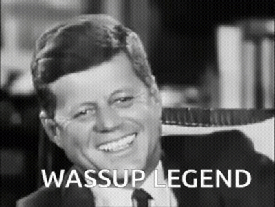 Man In Suit Smiling With Wassup Legend Text GIF