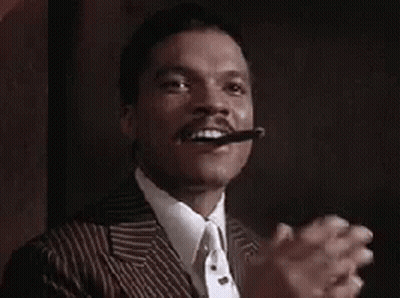 Man In Suit Smoking Cigar And Clapping GIF