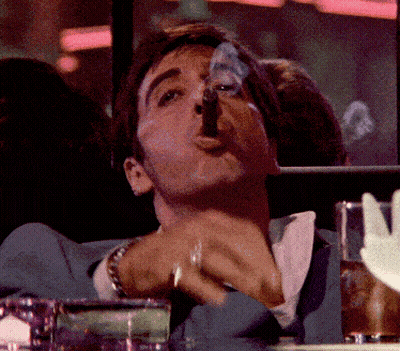 Man In Suit Smoking Cigar At Table GIF