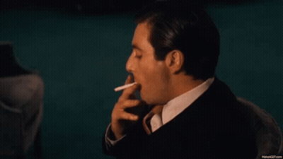 Man In Suit Smoking Cigarette GIF