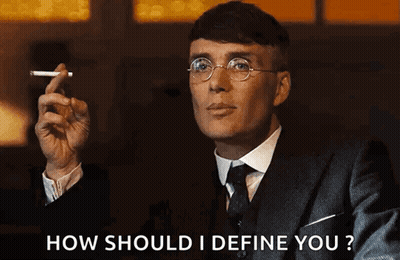 Man In Suit Smoking Cigarette Asking How To Define You GIF