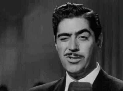Man In Suit Smoking Cigarette GIF