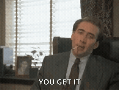 Man In Suit Smoking Cigarette In Chair GIF
