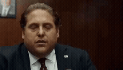 Man In Suit Smoking Cigarette In Dark Room GIF