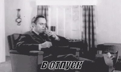 Man In Suit Smoking Cigarette In Living Room GIF