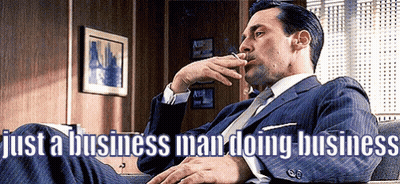 Man In Suit Smoking Cigarette Legs Crossed GIF